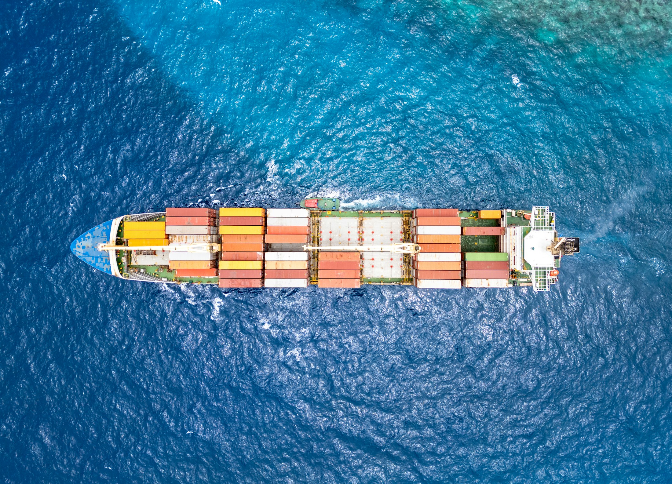 Aerial photograph of a container ship navigating open water